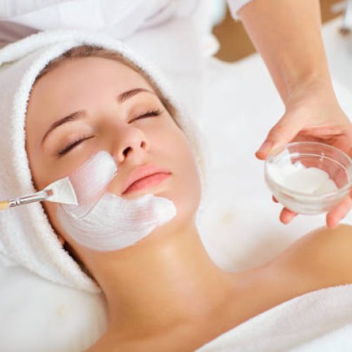 Woman in mask on face in spa beauty salon.